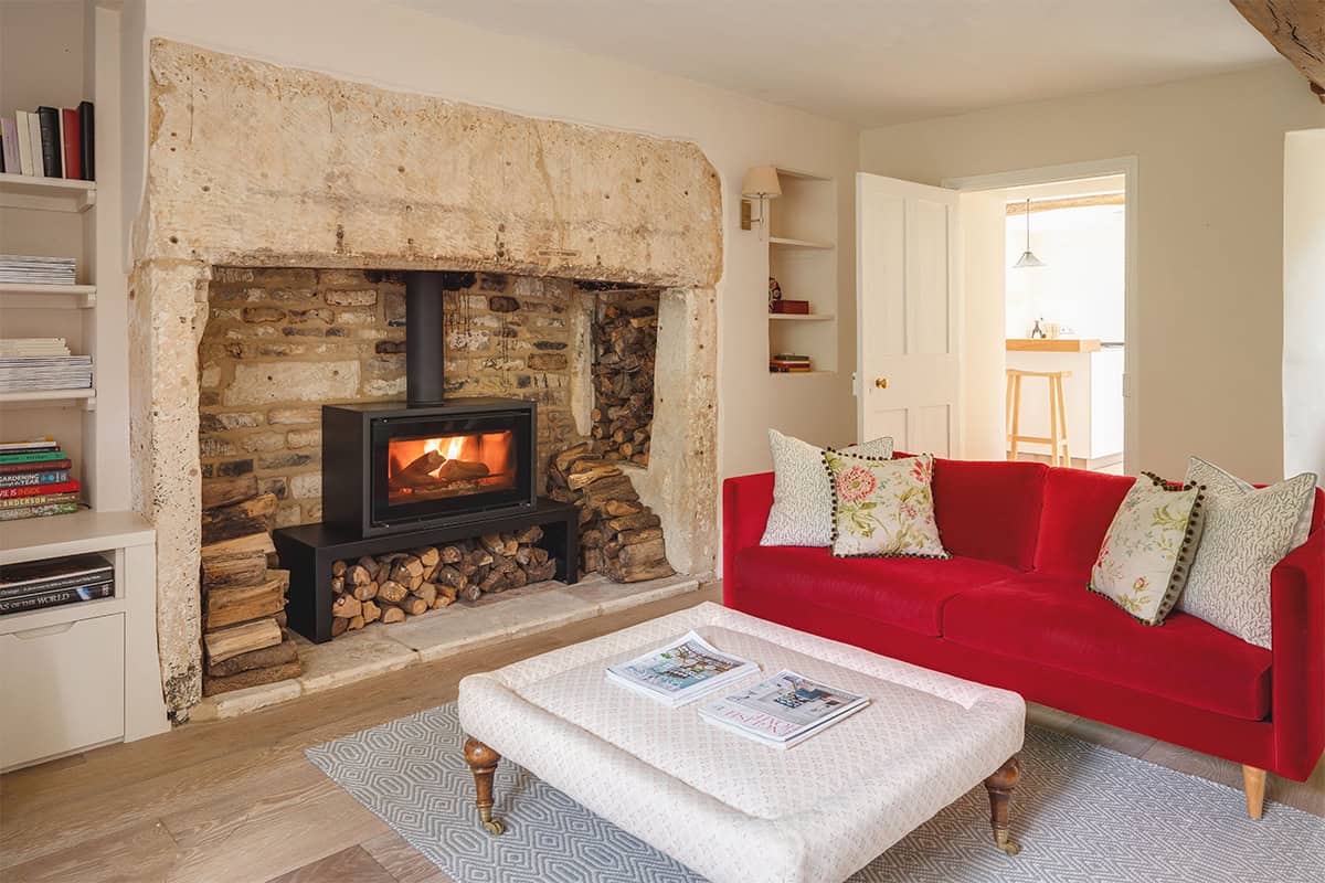The Mount snug with exposed stone walls, checked armchair, log basket and casement window, Stroud